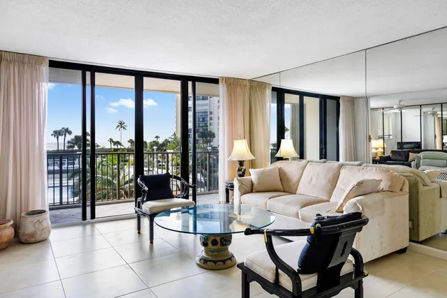 a living room with furniture and large windows