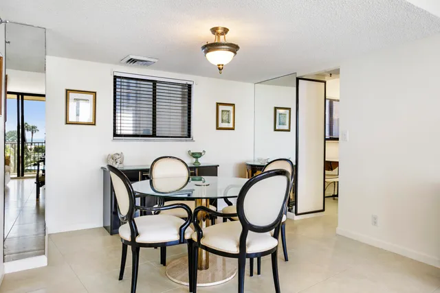a dining room with furniture and chandelier