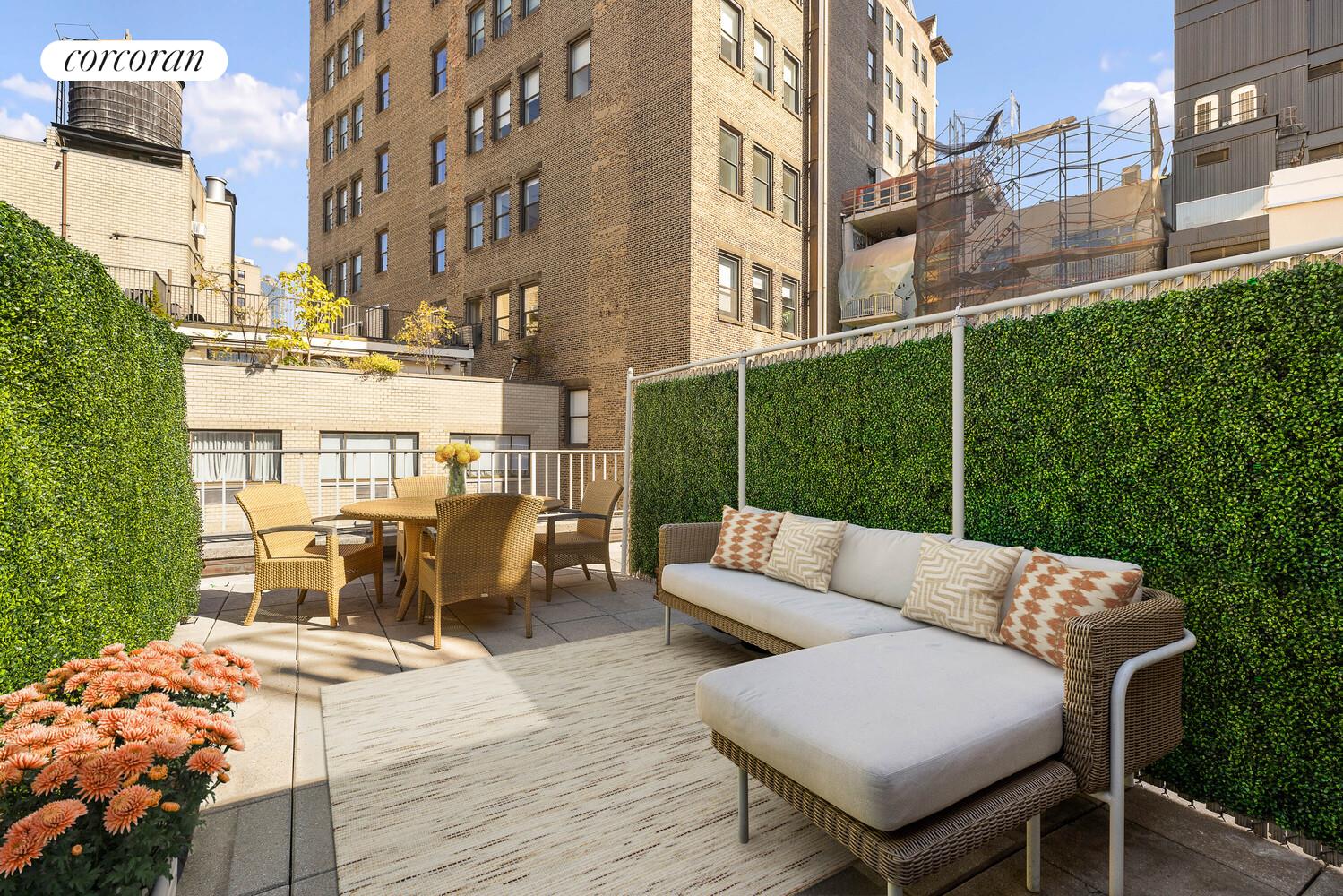 a view of a patio with couches table and chairs and wooden floor