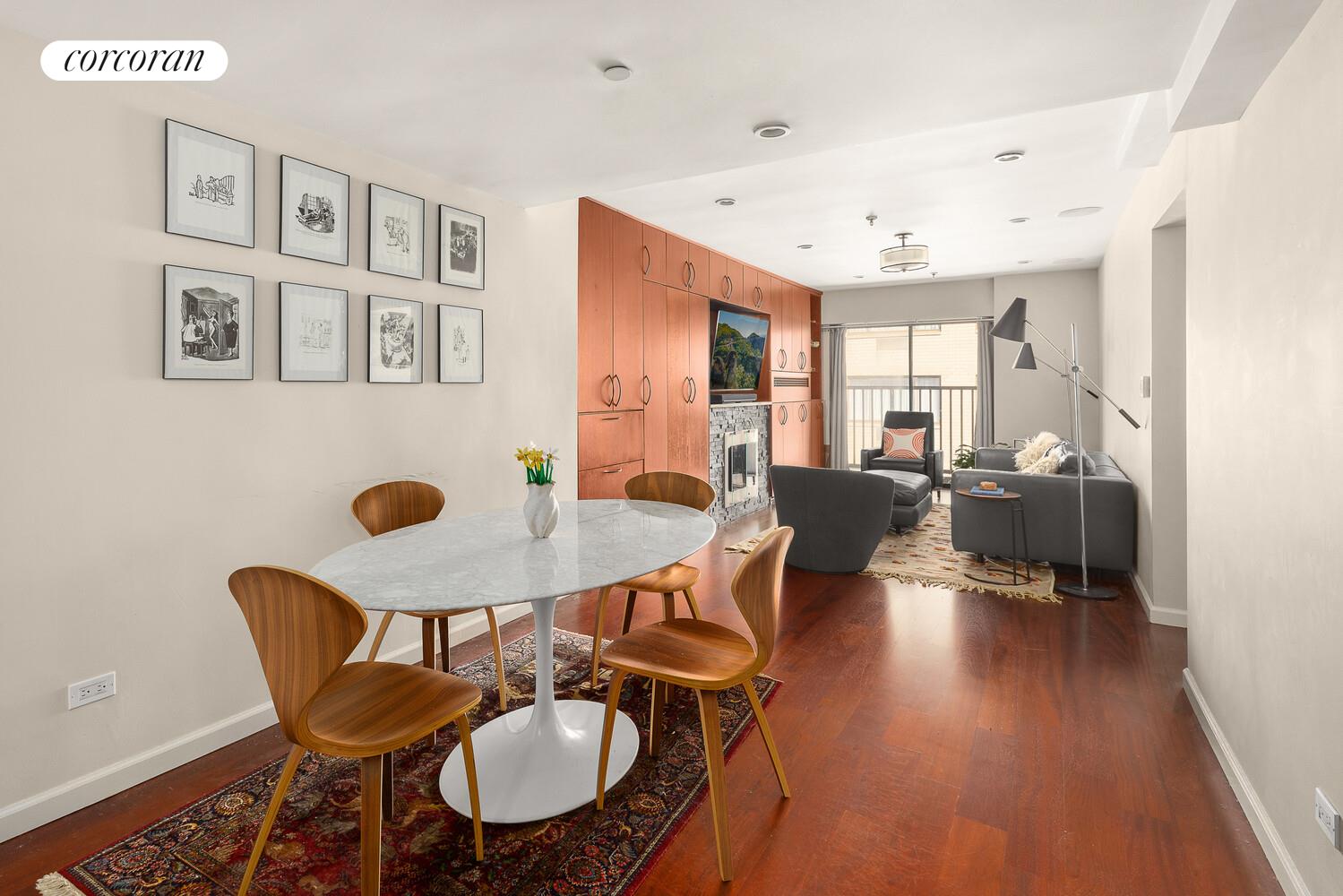67 East 11th Street, Unit 705 Manhattan, NY 10003 - Photo 2 of 10 a living room with furniture and wooden floor