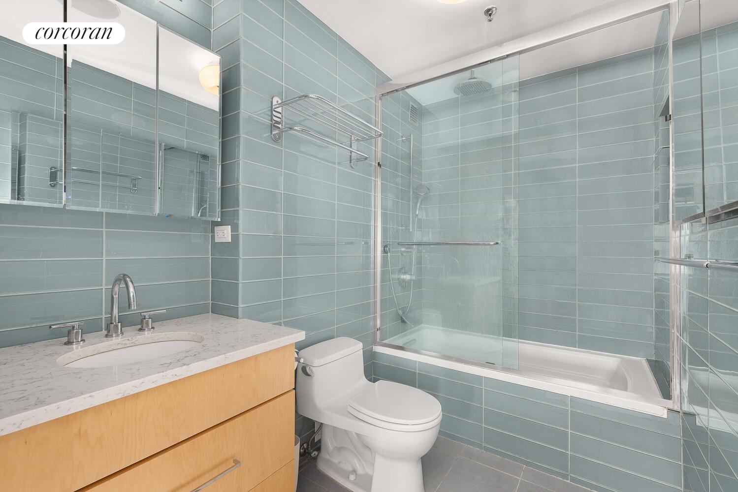67 East 11th Street, Unit 705 Manhattan, NY 10003 - Photo 7 of 10 a bathroom with a sink toilet and shower