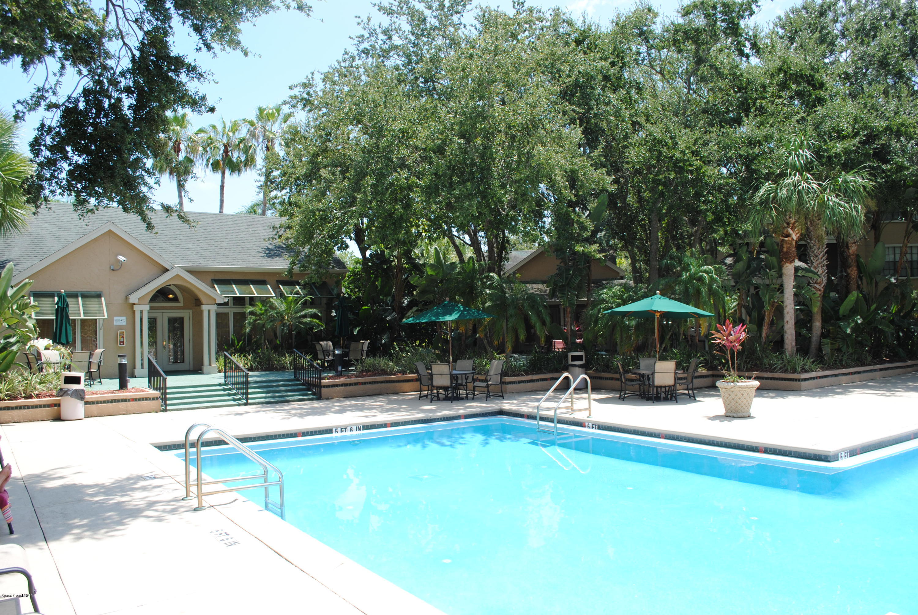7667 North Wickham Road, Unit 812 Melbourne, FL 32940 - Photo 14 of 17 a swimming pool with outdoor seating and yard