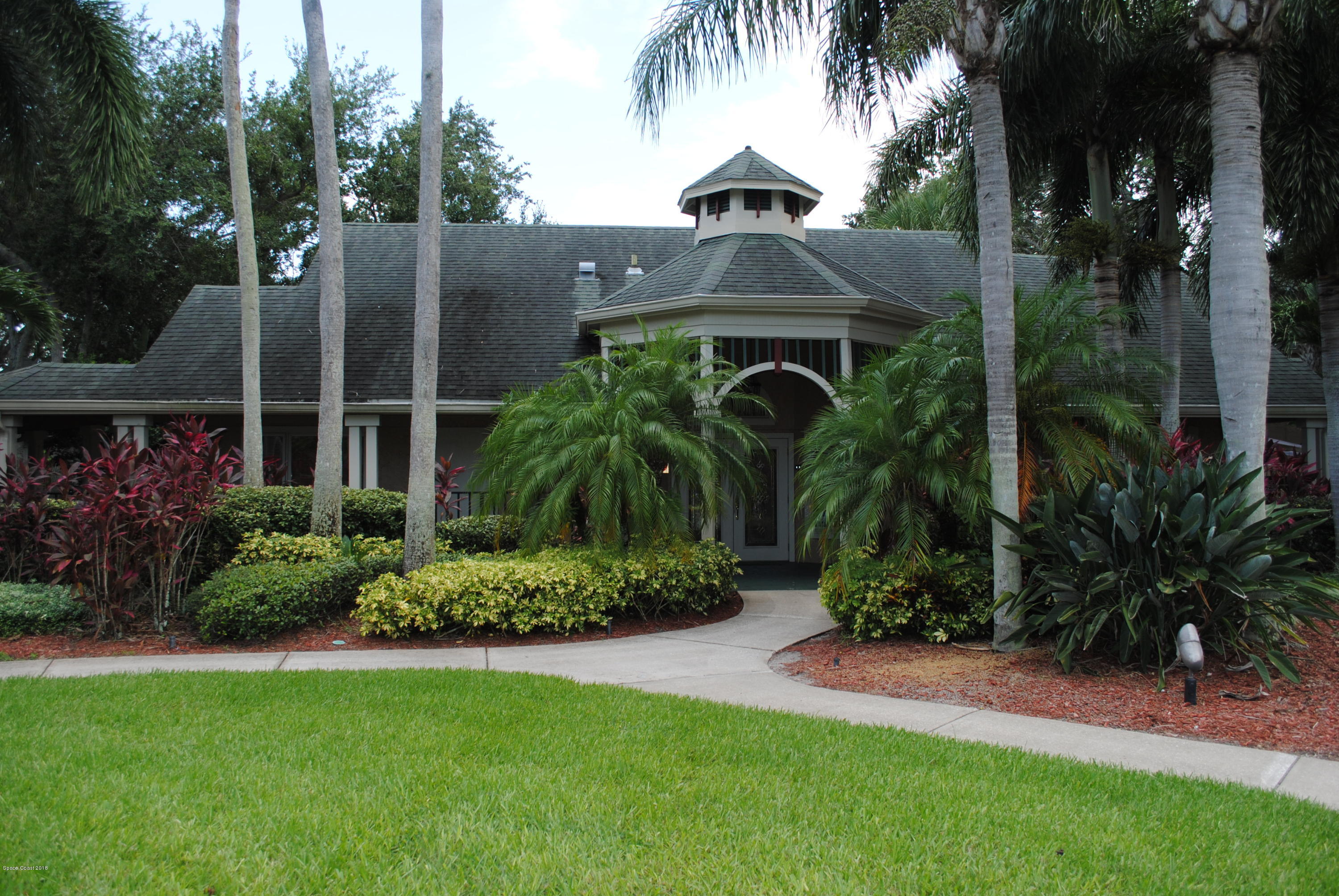 7667 North Wickham Road, Unit 812 Melbourne, FL 32940 - Photo 3 of 17 a front view of a house with garden