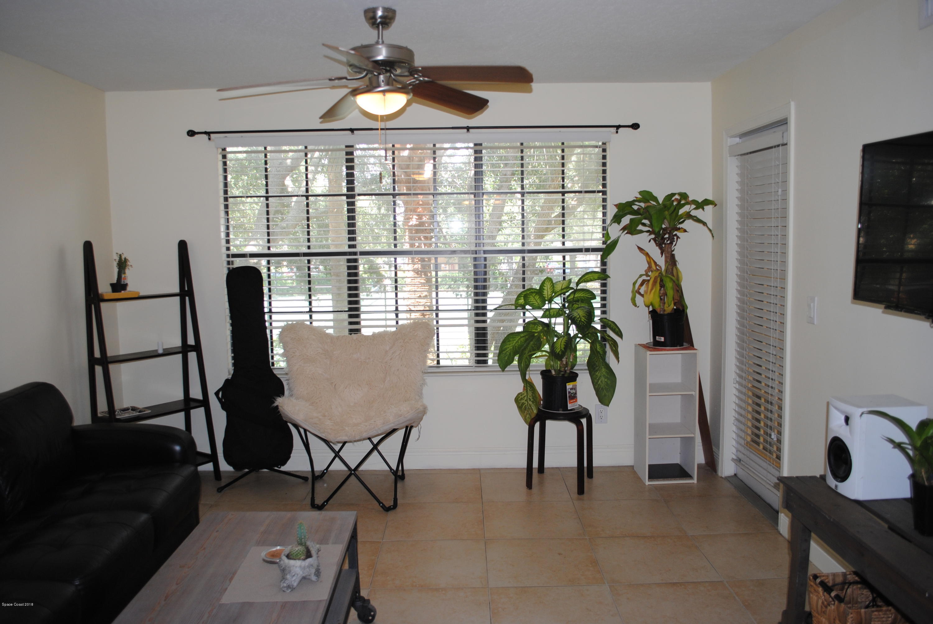 7667 North Wickham Road, Unit 812 Melbourne, FL 32940 - Photo 5 of 17 a view of a livingroom with furniture and a window
