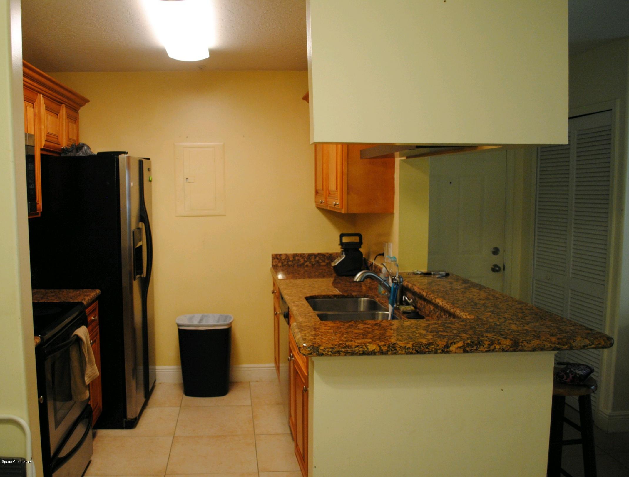 7667 North Wickham Road, Unit 812 Melbourne, FL 32940 - Photo 7 of 17 a bathroom with a granite countertop sink and a mirror