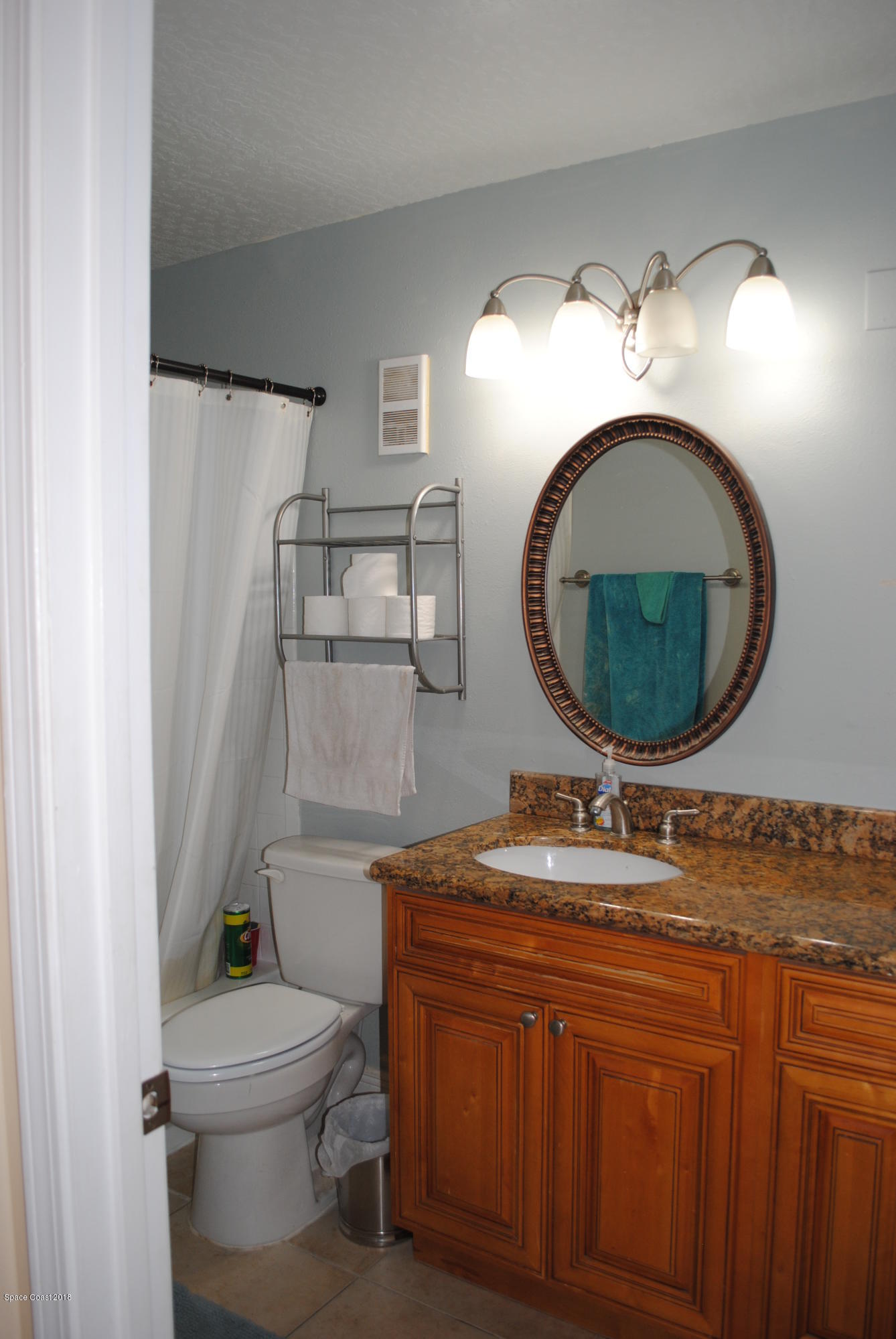7667 North Wickham Road, Unit 812 Melbourne, FL 32940 - Photo 8 of 17 a bathroom with a toilet a sink and a mirror
