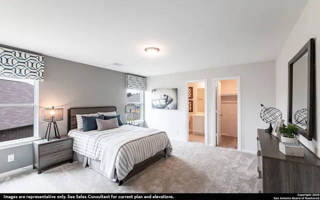 a bedroom with a large bed and a flat tv screen