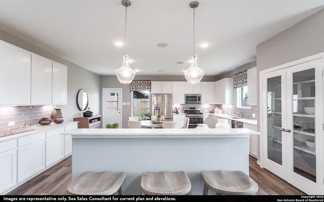 a kitchen with kitchen island granite countertop a sink cabinets and stainless steel appliances