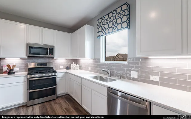 a kitchen with a sink stove and microwave