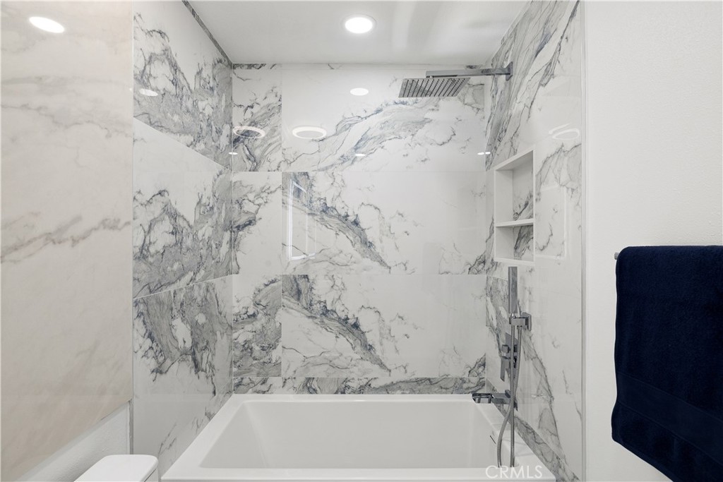 3004 Cardamon Street Rialto, CA 92376 - Photo 37 of 60 Guest Bathroom - with Backlit LED Mirror & Porcelain Slab- Full Secondary Bathroom featuring Soaking Tub & Designer Tile
Modern Guest Bath with Backlit Vanity Mirror & Rainfall Showerhead