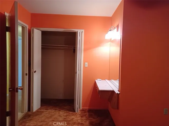 an empty room with a chandelier fan