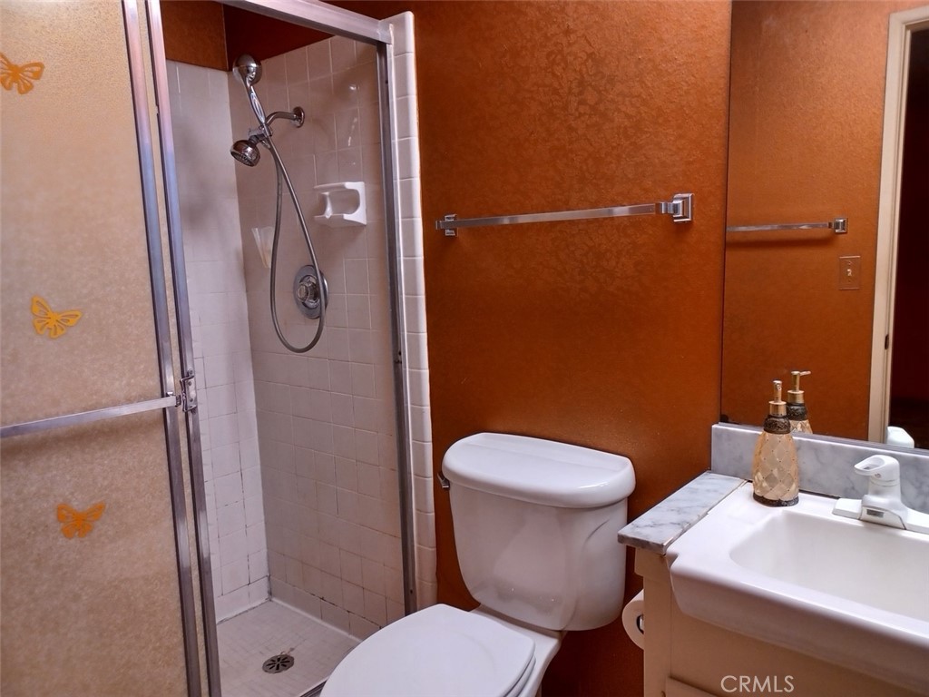 28751 Bradley Road Menifee, CA 92586 - Photo 12 of 19 a white toilet sitting next to a bathroom sink