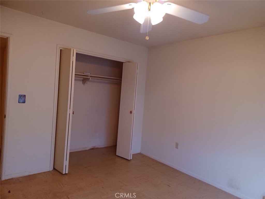 28751 Bradley Road Menifee, CA 92586 - Photo 13 of 19 an empty room with a chandelier fan