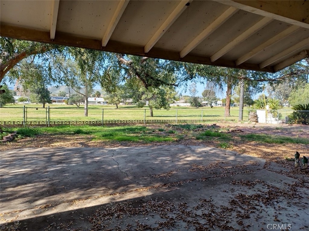28751 Bradley Road Menifee, CA 92586 - Photo 17 of 19 a view of a yard with a table and chairs under an umbrella