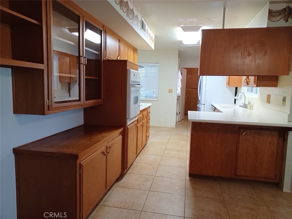 28751 Bradley Road Menifee, CA 92586 - Photo 3 of 19 a kitchen with stainless steel appliances a sink stove and cabinets