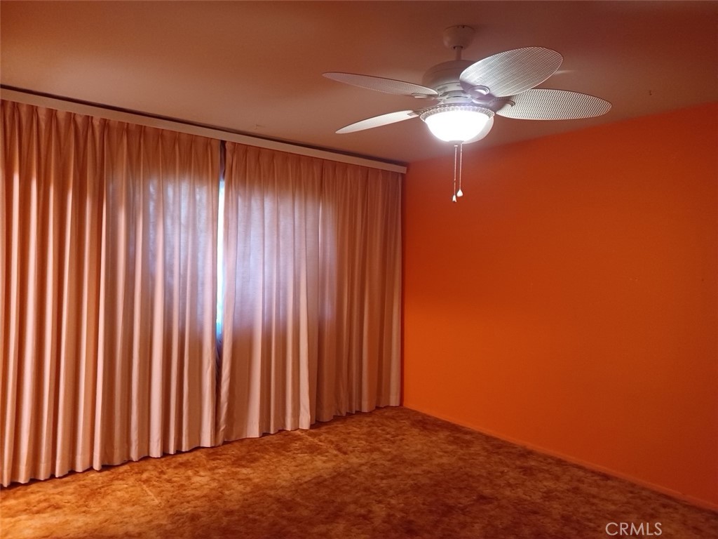 28751 Bradley Road Menifee, CA 92586 - Photo 9 of 19 an empty room with a chandelier fan