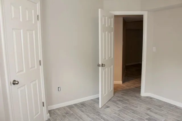 a view of a hallway with wooden floor
