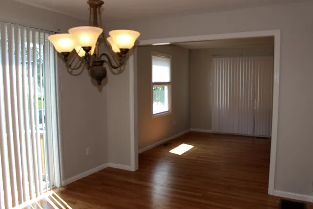a view of a chandelier fan and wooden floor