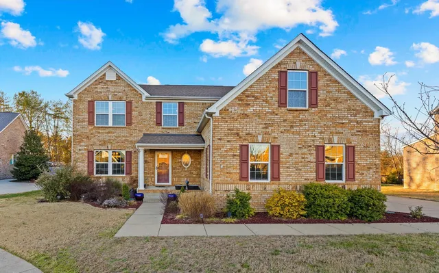 a view of a house with a yard and pathway