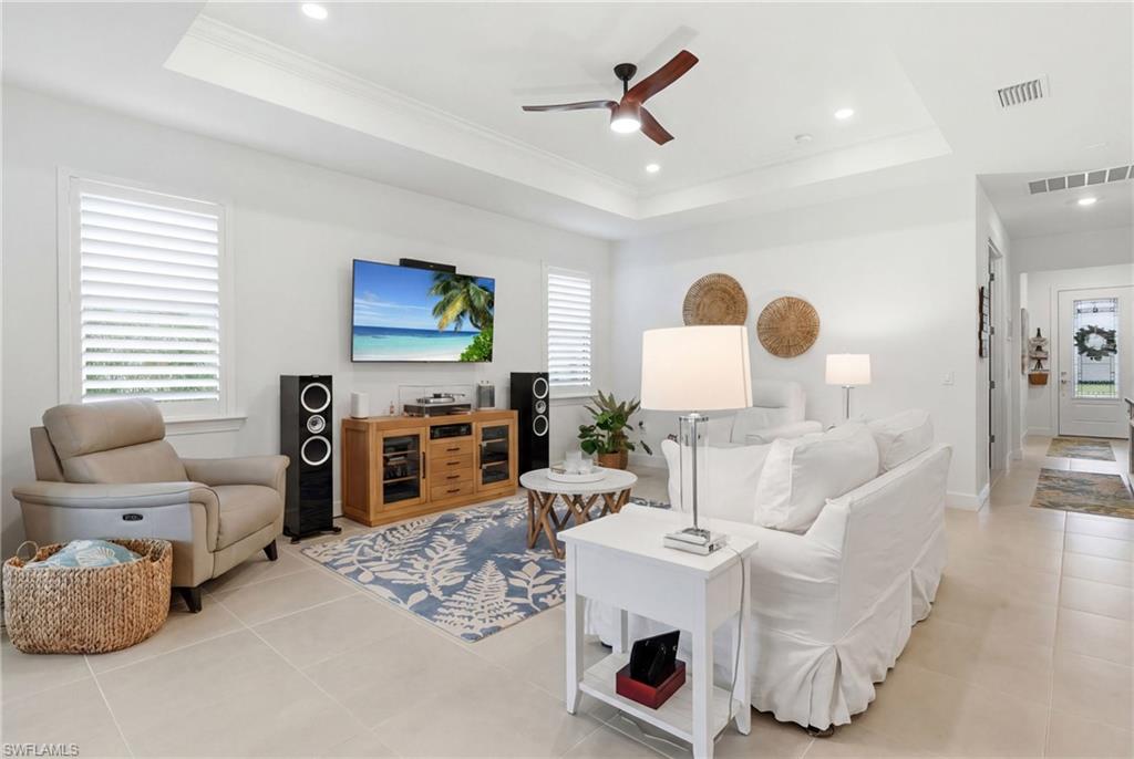 18364 Ridgeline Drive Estero, FL 33928 - Photo 9 of 50 a living room with furniture and a flat screen tv