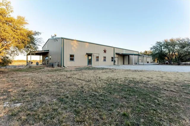 a front view of house with yard and trees