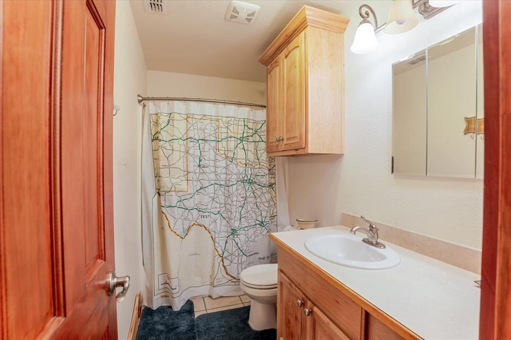 2117 Highway 6 Cisco, TX 76437 - Photo 17 of 35 a bathroom with a sink toilet and shower