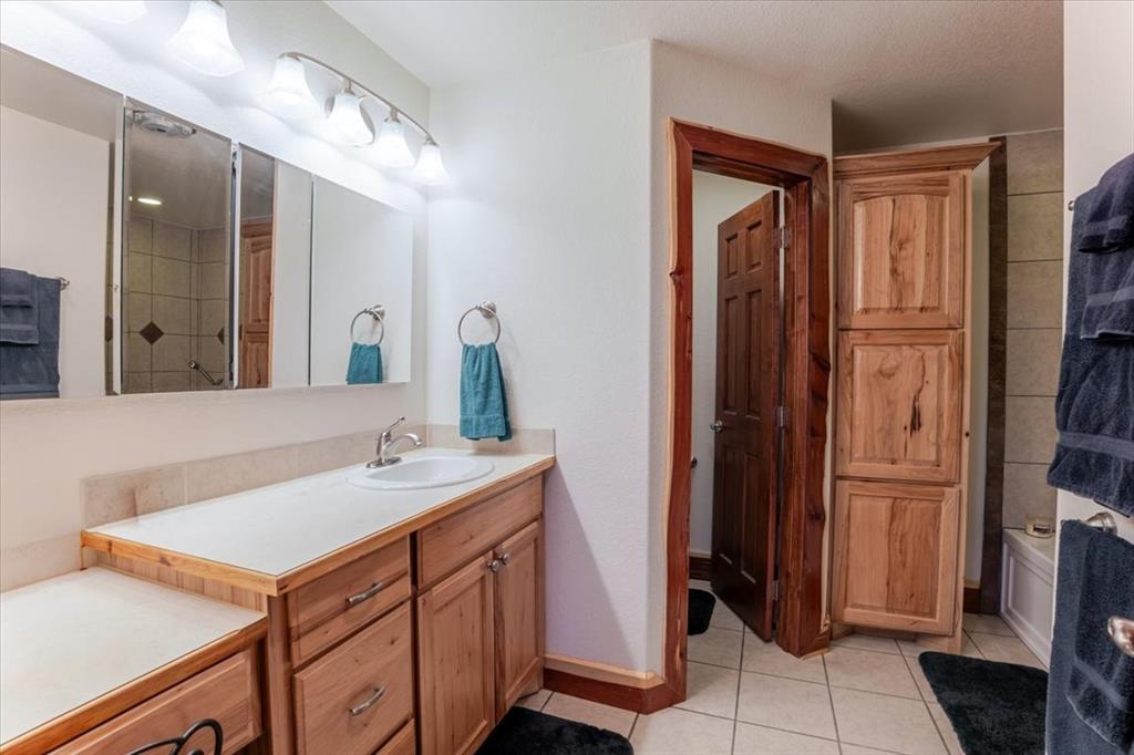 2117 Highway 6 Cisco, TX 76437 - Photo 6 of 35 a bathroom with a sink vanity and a mirror