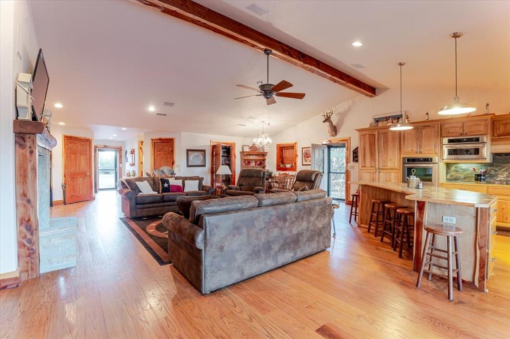 2117 Highway 6 Cisco, TX 76437 - Photo 9 of 35 a living room with furniture kitchen view and a wooden floor
