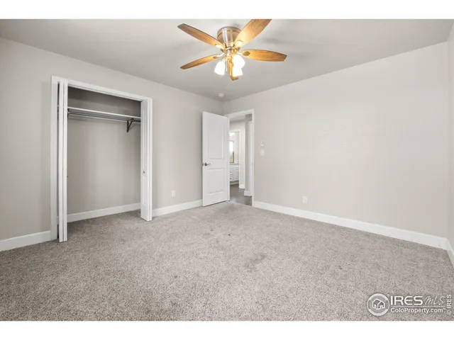 a view of an empty room with a ceiling fan