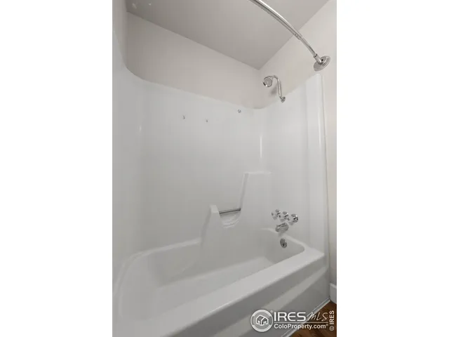 a bath tub sitting next to a white sink