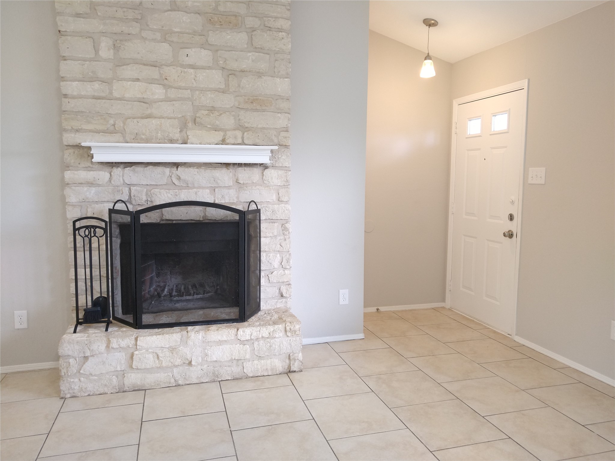 1813 Laurel Path Round Rock, TX 78664 - Photo 7 of 35 A striking stone fireplace hearth anchors this living area, offering warmth and visual interest.
