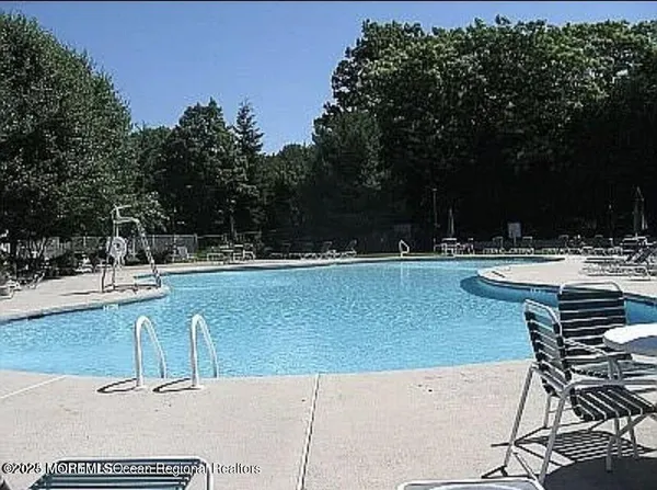 a view of swimming pool with outdoor seating