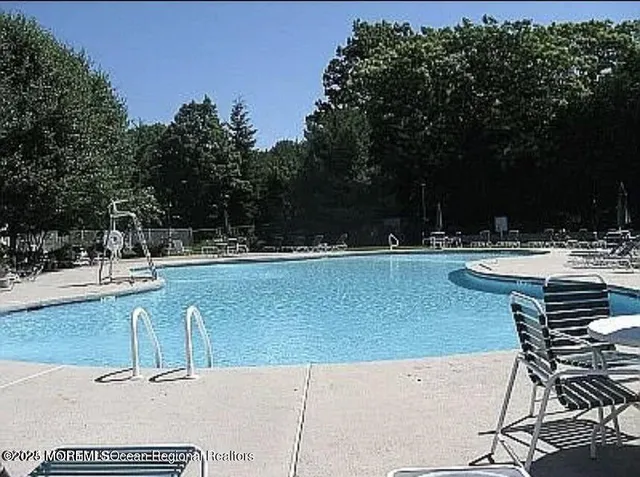 a view of swimming pool with outdoor seating