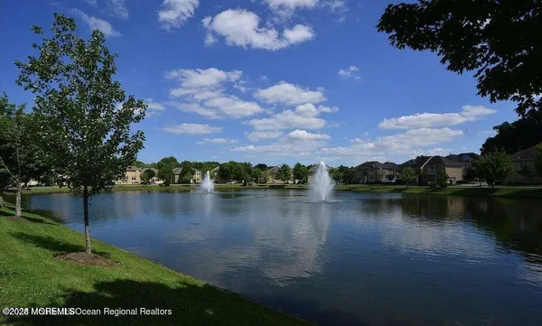 a view of a lake with houses in the back