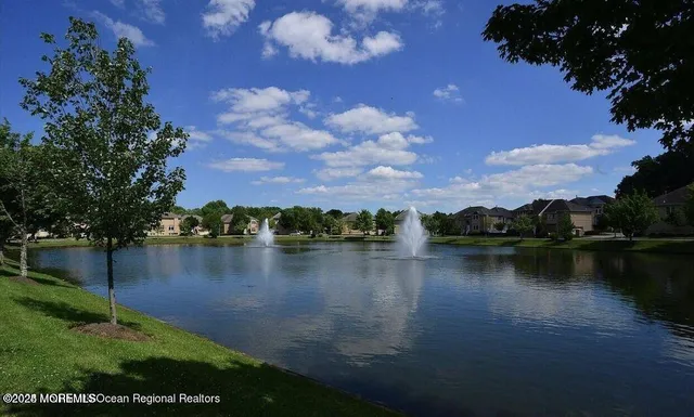 a view of a lake with houses in the back