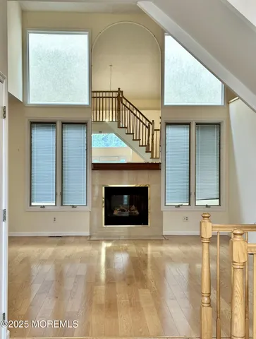 a view of an empty room with a fireplace and a window