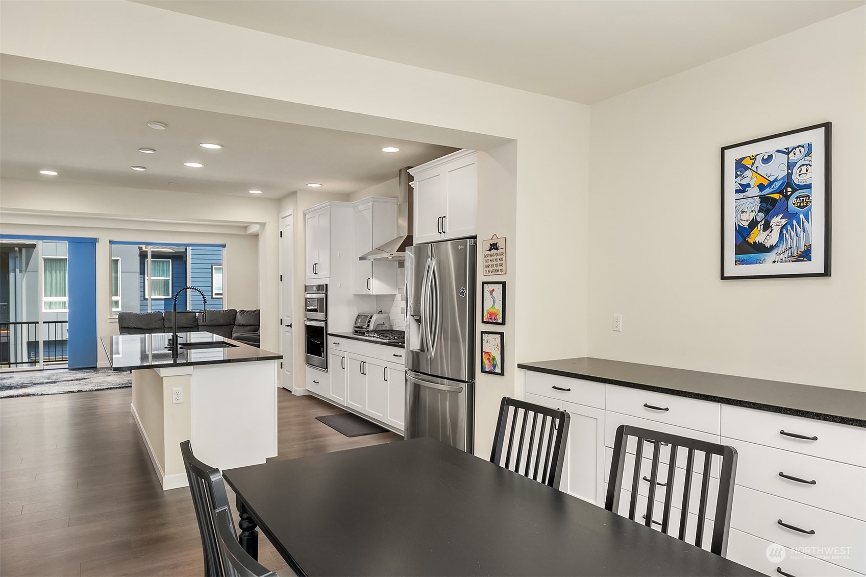 616 237th Place Southeast, Unit B Bothell, WA 98021 - Photo 12 of 33 a kitchen with stainless steel appliances granite countertop a refrigerator a stove and a sink with wooden floor