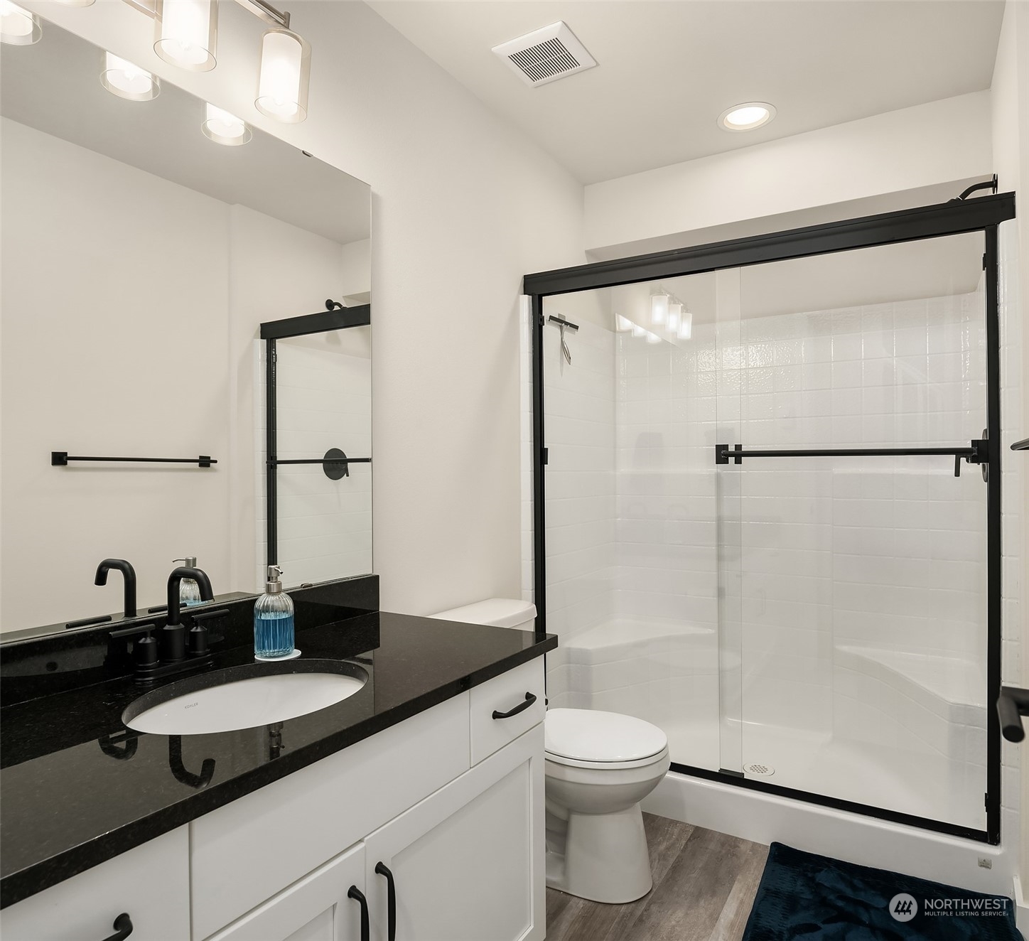 616 237th Place Southeast, Unit B Bothell, WA 98021 - Photo 28 of 33 a bathroom with a double vanity sink toilet mirror and shower