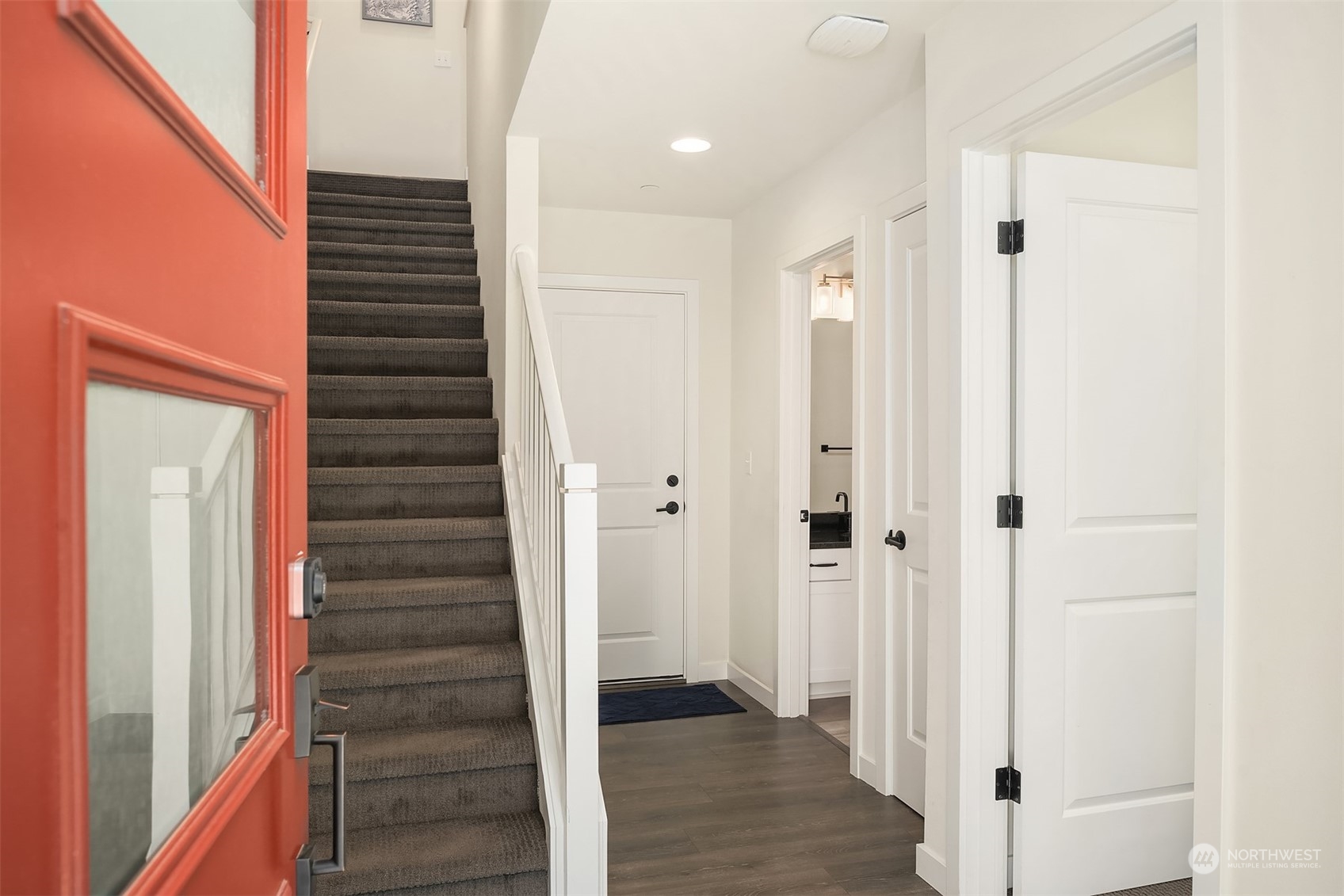 616 237th Place Southeast, Unit B Bothell, WA 98021 - Photo 3 of 33 a view of a hallway with wooden floor and staircase