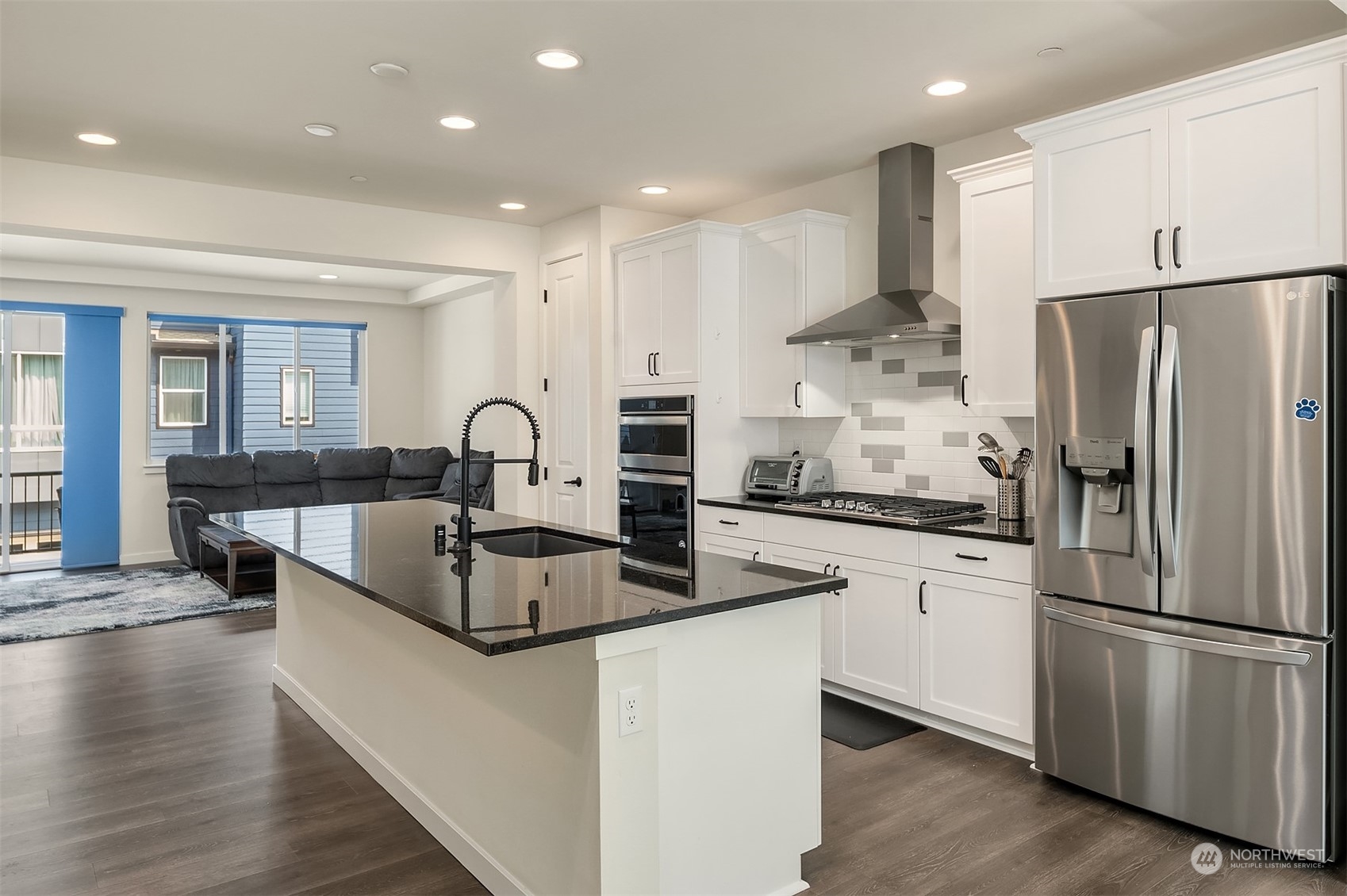 616 237th Place Southeast, Unit B Bothell, WA 98021 - Photo 5 of 33 a kitchen with stainless steel appliances granite countertop a refrigerator sink and cabinets