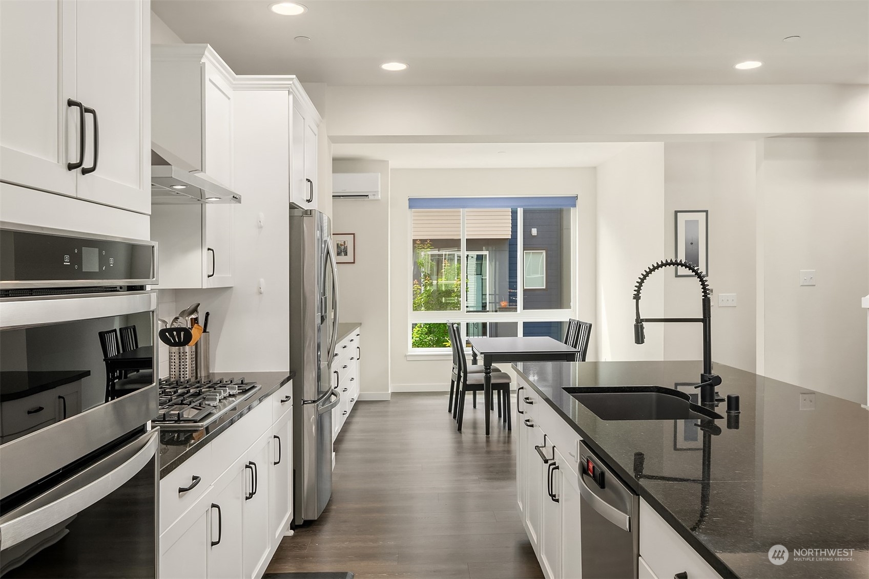 616 237th Place Southeast, Unit B Bothell, WA 98021 - Photo 6 of 33 a kitchen with granite countertop a stove a sink and a refrigerator