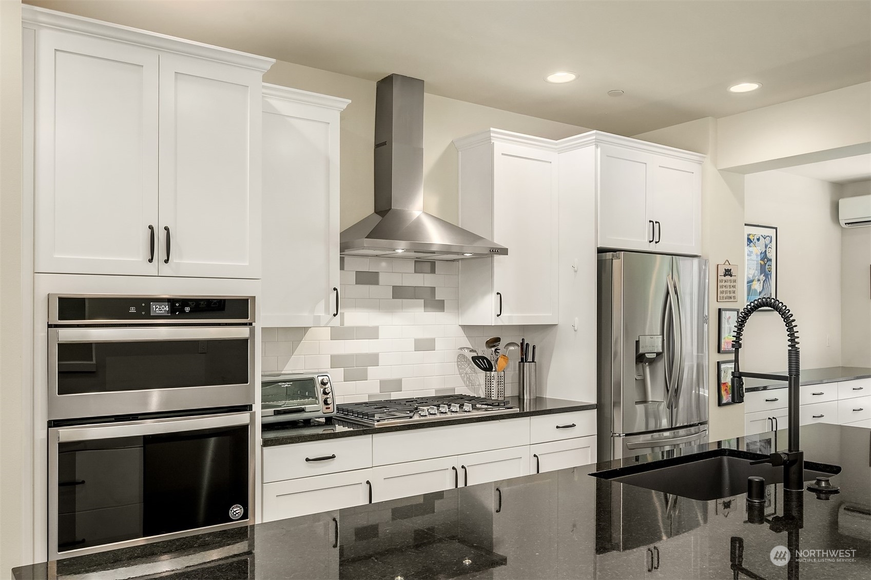 616 237th Place Southeast, Unit B Bothell, WA 98021 - Photo 7 of 33 a kitchen with stainless steel appliances granite countertop a stove a refrigerator and a granite counter tops with white cabinets