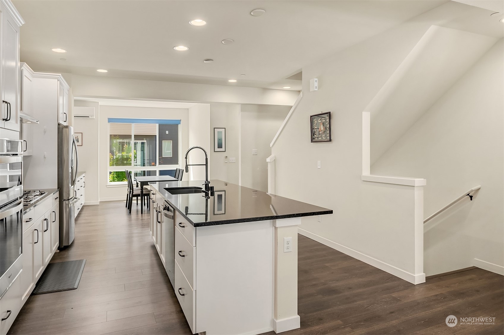 616 237th Place Southeast, Unit B Bothell, WA 98021 - Photo 10 of 33 a kitchen with stainless steel appliances granite countertop a sink a stove and a refrigerator