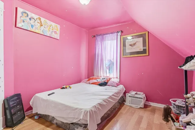 a bedroom with a bed and a dresser