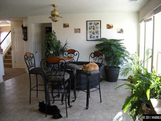 8931 Grisom Way Reno, NV 89506 - Photo 5 of 13 a dining room with furniture and a potted plant