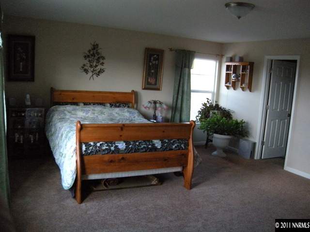 8931 Grisom Way Reno, NV 89506 - Photo 6 of 13 a bed sitting in a room next to a window