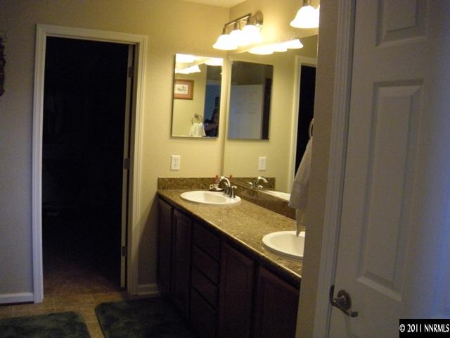 8931 Grisom Way Reno, NV 89506 - Photo 10 of 13 a bathroom with a granite countertop sink and a mirror