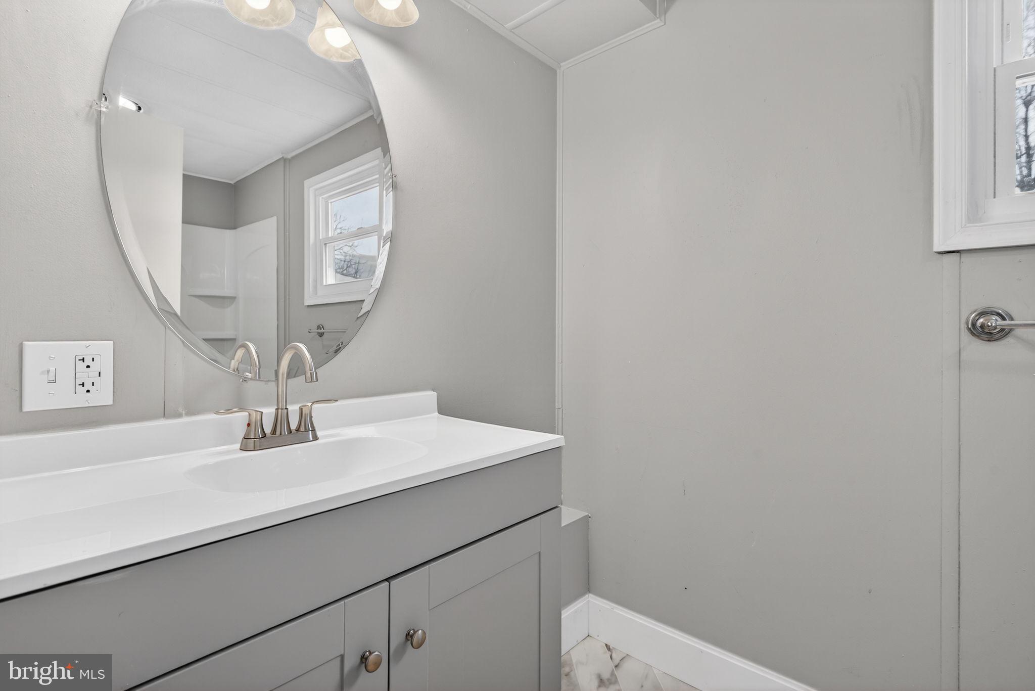 4918 Pleasant Valley Road York, PA 17406 - Photo 18 of 30 a bathroom with a sink a vanity and a mirror