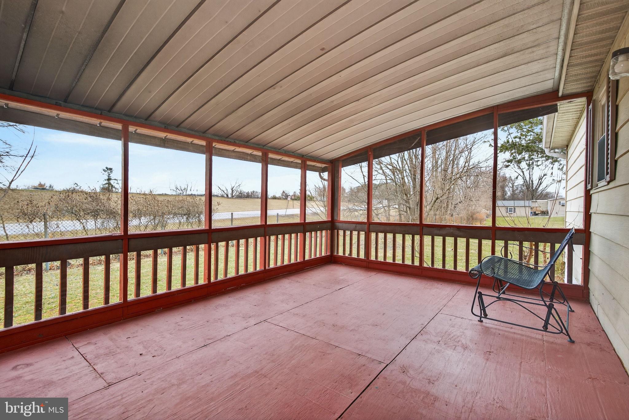 4918 Pleasant Valley Road York, PA 17406 - Photo 26 of 30 a view of a porch with a table and chairs