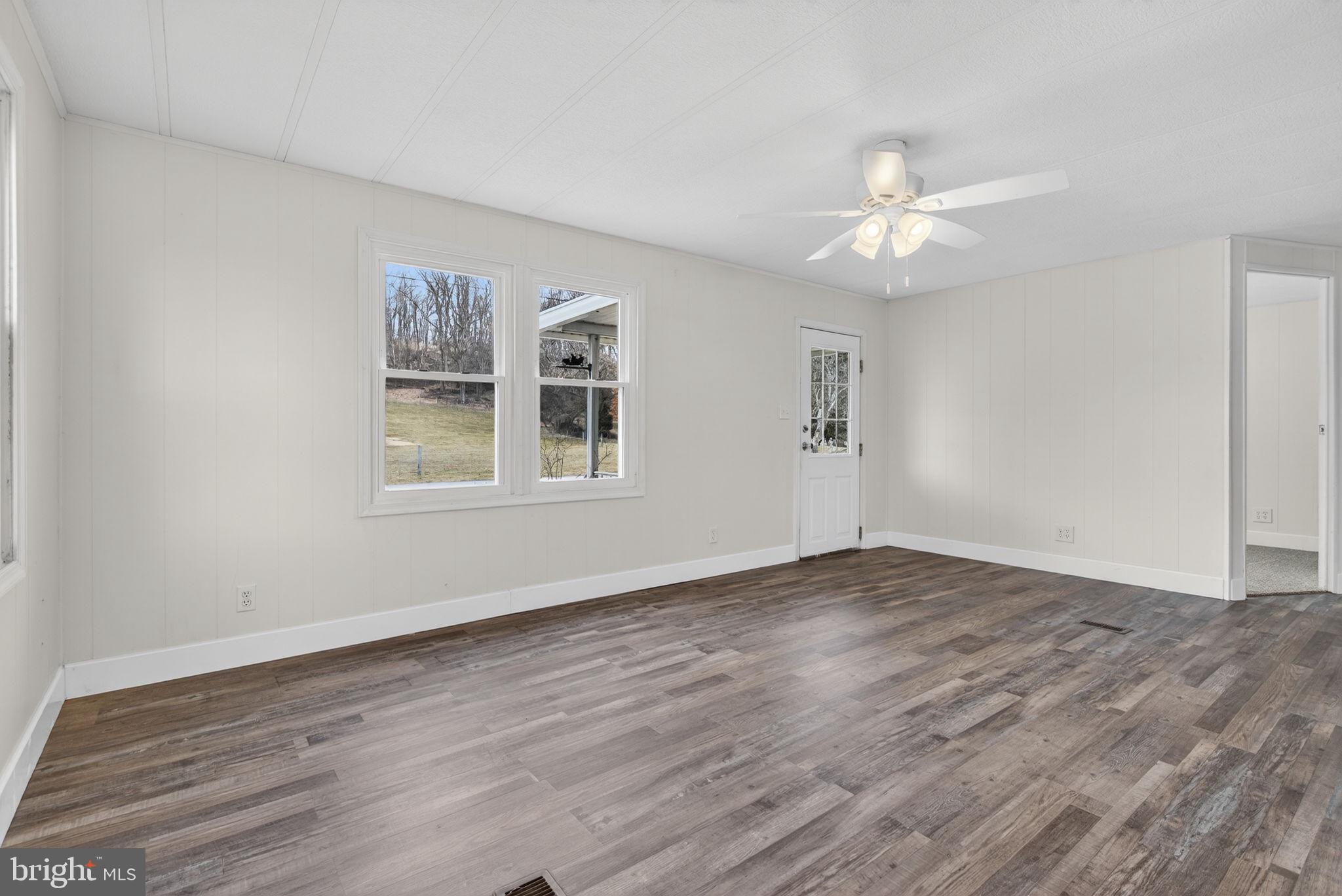 4918 Pleasant Valley Road York, PA 17406 - Photo 5 of 30 a view of an empty room with wooden floor and a window